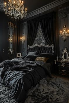 a black bedroom with chandelier, bed and mirror on the wall next to it