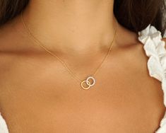 "Feel divine in this Intertwined Two-Toned Circles Necklace. This piece is simple yet stunning with one circle covered in 1/5tcw diamonds. It enriches your style with the most exquisite touches of elegance. This winsome pendant is stationed on a 14kt yellow gold link chain. With interlocking circles, one is crafted in brushed yellow gold, and the other is forged in white gold with sparkling white diamonds for a gorgeous two-toned effect. This unique pendant can be paired with other pieces bringing a refined look to any outfit. 100% Handmade in Boca Raton, FL Each necklace is made to order.  Production time: Please allow 5-7 days Stone Type: Natural Diamonds Total Carat Weight: 0.18 Diamond color: H Diamond clarity: I3 Necklace Length: 16\" with 2\" extender Clasp Type: Lobster Claw  Averag Two Tone Necklace, Amman Outfits, Bday Wishlist, Eternity Necklace, Interlocking Circle Necklace, Diamond Circle Pendant, Gold Circle Necklace, Gold Link Chain, Gold Link