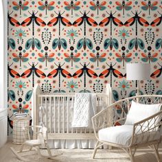 a white crib in front of a colorful wallpaper with dragonflies on it