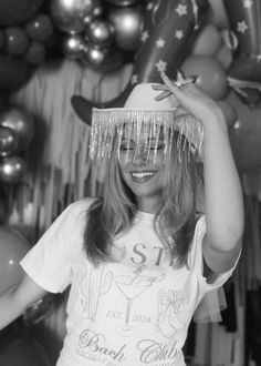 black and white photograph of a woman wearing a party hat