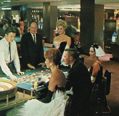 a group of people sitting around a casino table