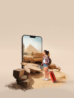 a woman standing in front of a cell phone with the image of a pyramid behind her