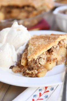 a piece of pie on a plate with ice cream