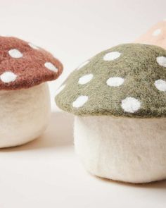 two small mushrooms with white dots on them sitting next to each other in front of a white background