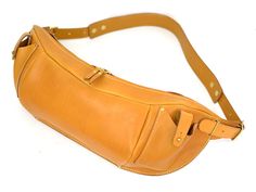 a tan leather fanny bag on a white background