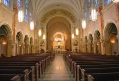 an empty church with pews and stained glass windows