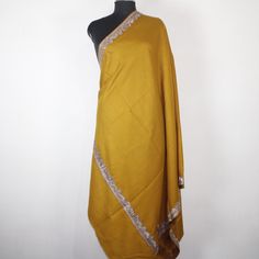 Kashmiri Tilla/Zari Embroidered Wool Shawl.This Shawl Is Made Of Fine Merino Wool Its Embroidered With Tilla Work.The Embroidery Done On This Is A Traditional Kashmiri Embroidery Known As 'Tilla Work''.Now Own A Rare Genuine Kashmiri Hand Embroidered Shawl Which Takes Many Months To Create, Unique In Design And Colour And, Have Never Been Replicated. Condition: Brand New Size: 40" X 80" (100 Cm X 200 Cm) Approx Colour: mustard Style: Shawl Wrap Material: Fine Merino Wool Design: paladar Embroide Embroidered Yellow Jamawar Traditional Wear, Gold Embroidered Jamawar Fabric, Winter Embroidered Dupatta With Traditional Drape, Winter Festive Embroidered Pashmina Shawl, Embroidered Festive Winter Pashmina Shawl, Festive Ceremonial Shawl With Embroidered Border, Festive Winter Dupatta With Embroidered Border, Winter Festive Embroidered Shawl, Kashmiri Tilla Embroidery