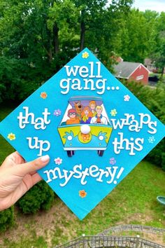 someone holding up a blue graduation cap with the words well gang that wraps up this mystery