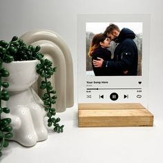 a couple is kissing in front of an audio player