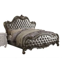 an antique style bed with tufted headboard and foot board