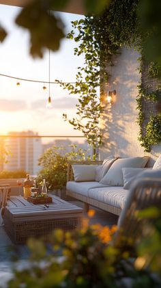 an outdoor living area with wicker furniture and potted plants on the balcony at sunset