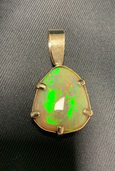 25.00 ct. Ethiopian Opal in 14K yellow gold pendant.  Please look at the photos and make sure this item is what you need before purchasing. All sales are final. Etsy charges state tax. Item will ship when funds clear Etsy's 5 business days hold. Luxury Ethiopian Opal Pendant Jewelry, Yellow Gold Pendants, Honolulu, Ethiopian Opal, Gold Pendant, Pendant Necklaces, Favorite Jewelry, Jewelry Necklace Pendant, Opal