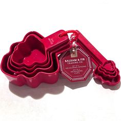 three red cookie pans with matching cutters