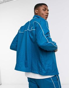 Track jacket by PUMA High neck Zip fastening Long sleeves Elasticated cuffs Side pockets Logo patch to front Contrast piping Regular fit True to size Blue Streetwear Outerwear With Side Pockets, Blue Sporty Outerwear With Ribbed Cuffs, Blue Casual Windbreaker With Ribbed Cuffs, Sporty Blue Outerwear With Ribbed Cuffs, Casual Blue Windbreaker With Ribbed Cuffs, Blue Athleisure Track Jacket For Spring, Blue Long Sleeve Windbreaker With Ribbed Cuffs, Blue Long-sleeved Windbreaker With Pockets, Athleisure Blue Track Jacket With Ribbed Cuffs