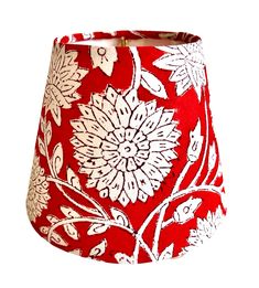 a red and white flowered lamp shade on a white background with clippings