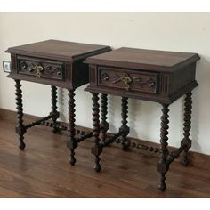 two wooden side tables sitting next to each other on top of a hard wood floor