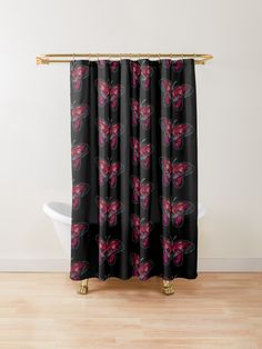 a black shower curtain with pink butterflies on it