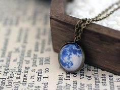 Beautiful and unique, Space necklace, featuring an image of a Blue Moon. A great gift for you or anyone in love with the night sky and the Solar system! Chain length is 48cm/19" and the diameter of the image is 16mm. ☀ You can see more from Sun and Stars Jewelry here - sunandstarsjewelry.etsy.com⋆ More Space Jewelry - https://www.etsy.com/shop/SunAndStarsJewelry?section_id=14349961&ref=shopsection_leftnav_1----------------------------------------------------☀ Product care:⋆ avoid contact wit Blue Full Moon, Blue Moon Necklace, Stars Jewelry, Full Moon Necklace, Space Necklace, Moon Full, Moon Space, Galaxy Jewelry, Moon Blue