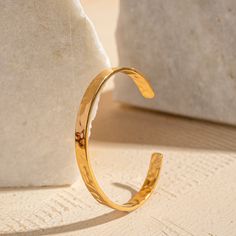 Discover our handcrafted textured bangle, made from the finest quality metal. These minimal yet versatile bangle transition effortlessly from day to night, and from casual to dressy wear. Featuring thick 2-micron gold plating, they are anti-tarnish and designed to last. Light in weight yet statement-making, this bangle is a timeless addition to any jewelry collection.This bangle is adjustable completely hypoallergenic. Elegant Hammered Brass Bangle, Everyday Tarnish Resistant Cuff Bangle, Minimalist Metal Bangle Tarnish Resistant, Hammered Metal Bangle As Gift, Hammered Yellow Gold Bangle For Everyday, Modern Gold Hammered Cuff Bracelet, Hammered Metal Bangle Gift, Minimalist Hammered Bracelet Bangle, Modern Hammered Gold Cuff Bracelet