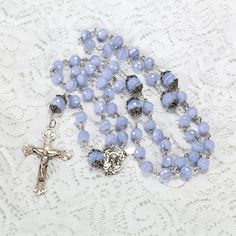 "Blue Lace Agate is such a soft, soothing stone that is makes an elegant, graceful rosary. Naturally, the rest of the details must be delicate to keep up with the beauty of the Blue Lace Agate. Do not be worried though, although it appears dainty, the stone itself is actually very strong to ensure it will be an heirloom rosary and guide prayers for generations to come. #87A This stunning Blue Lace Agate catholic rosary is made with 8mm faceted stones. The 10mm Our Father beads are capped with st Elegant Healing Rosary With Round Beads, Elegant Rosary With Round Beads For Healing, Elegant Healing Rosary, Rosary Gift, Custom Rosary, Catholic Women, Catholic Rosary, Our Father, Rosary Catholic