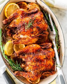 roasted chicken with lemons and rosemary in a pan