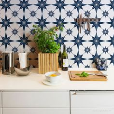 a kitchen counter topped with a bowl of food and utensils next to a cutting board