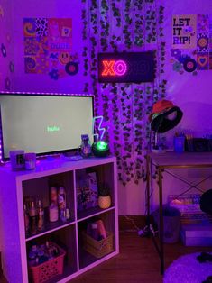 a living room with purple lighting and various items on the shelves in front of it