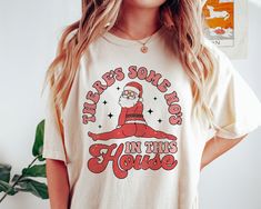 a woman wearing a santa clause t - shirt