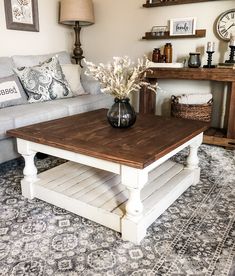 a living room with a couch, coffee table and other items on the carpeted floor