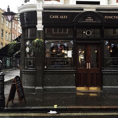 the front of a restaurant with wooden doors