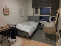 a bedroom with a bed, desk and chair