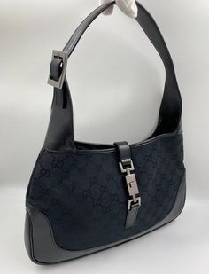 A stunning vintage Gucci Jackie bag made from black canvas with black leather trim and silver hardware. This bag also has the iconic Gucci pin lock closure. Inside the bag is lined with the black Gucci nylon lining and there is a zipped pocket for valuables. This bag is in exceptional vintage condition, a true collectors item and comes with its original Gucci dust bag. Vintage Gucci Jackie, Pin Lock, Vuitton Bag, Diaper Backpack, Black Canvas, Casual Backpack, Handbag Backpack, Kids Bags, Leather Trim