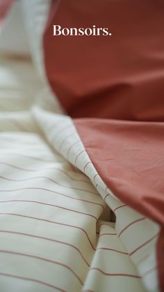 an image of a bed with red and white sheets