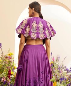 Editor's Note Featuring a purple chanderi contrast cordwork and beadwork cape Note: Lehenga and ivory inner top worn by model is for styling purposes and can be purchased separately. Color: Purple Fabric: Chanderi Component: Cape top Occasion: Festive and daywear Care: Dry Clean Only About the Designer Chandrima celebrates diversity in cultures and craft forms creating ready-to-wear women wear for the urban woman of today. The brand embodies the idea of Indian handloom and craft merged with an i Reception Choli With Cutdana And Cape Sleeves, Embroidered Festival Sets With Cape Sleeves, Festival Embroidered Sets With Cape Sleeves, Anarkali Choli With Cape Sleeves, Designer Traditional Wear With Embroidered Cape Sleeves, Designer Embroidered Traditional Wear With Cape Sleeves, Festive Embroidered Lehenga With Cape Sleeves, Embroidered Choli With Cape Sleeves For Reception, Diwali Choli With Cutdana And Cape Sleeves