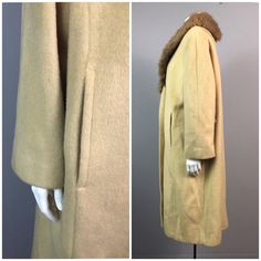 Vintage NOS Deadstock 1960's Beige Wool Long Coat With Mink Fur Collar / Women's XL / 60's Bombshell Rockabilly Swing CoatFeatures:• Beige wool Coat.• Mink fur collar.• 2 oversized buttons at front.• Slightly cropped sleeve length.• 2 waist pockets. • Material: wool with mink collar. • Lined in rayon/acetate. • Circa 1950's or 1960's.Measurements:• Taken laying flat and doubled where necessary • Best fit women's XLBust- up to 42"Waist- 38"Hips- 46"Length- 39 1/2Arm Length- 21 1/4" slightly croppedShoulders- 17"Label: Crestmoor Condition: Great vintage condition with the original 1960's store tags still attached. Fitted Vintage Wool Coat, Vintage Outerwear For Winter Daywear, Mid-century Long Sleeve Winter Outerwear, Wool Outerwear For Vintage Fashion With Long Sleeves, Vintage Fitted Wool Coat For Winter, Vintage Beige Outerwear For Daywear, Vintage Brown Wool Coat, 60s Bombshell, Beige Wool Coat