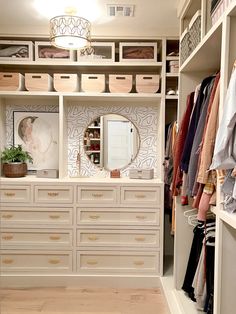 an organized closet with white drawers and gold handles