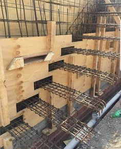 the foundation of a building being constructed with steel bars and wooden boards on each side