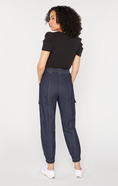 Stylishly functional, our Kelly Pant offers the perfect combination of cargo pocket, tapered silhouette, mid rise, indigo denim, and stretch for an off-duty look. Contrast stitching and a zipper fly closure complete the ensemble. Details Button and zipper flyFabric: Indigo DenimCroppedCargo style pocket detail Elastic cuffs Content and Care 77% Cotton 21% Polyester 2% ElastaneDry Clean OnlyImported Measurements 27.5in/43.82cm, inseamMeasurements from size 4Dyes from some clothing, such as those Pant Details, Indigo Denim, Cargo Pocket, Fashion Joggers, Denim Pant, Contrast Stitch, Pocket Detail, Denim Fashion, Mom Jeans