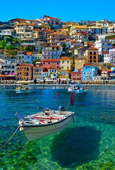 a puzzle piece with a boat in the water and houses on the hill behind it