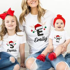 Personalized Christmas  Family T-shirt, Family Christmas Name Shirt, Customized Christmas Family  Shirt, Custom Christmas Shirt With Name. Our personalized t-shirts are made from high-quality materials that feels great against your skin. With a range of colors and designs to choose from, you're sure to find a shirt that matches your personality and style. Whether you're looking for a funny graphic tee, a statement piece with bold, eye-catching artwork, or a classic design with a twist, we have s Family Matching Holiday T-shirt With Letter Print, White Christmas Tops With Custom Print, White Letter Print Shirt For Holiday, White Custom Print Christmas Tops, White Top With Custom Print For Holidays, Family Matching Christmas T-shirt With Letter Print, Family Matching White Christmas Tops, Family Matching White Tops For Christmas, White Custom Print Tops For Holiday