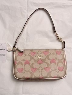 NWT Coach Nolita 19 In Signature Canvas With Heart Print CQ144 COLORS:GOLD/LIGHT KHAKI CHALK MULTI 2024 Valentine’s Day Collection Signature coated canvas and smooth leather Two credit card slots Inside multifunction pocket Zip-top closure, fabric lining Handle with 6 1/4" drop Size: 7 1/2" (L) x 4 1/2" (H) x 2" (W) Style No. CQ144 Coach Nolita 19, Outfit Ideas Pink, Coach Nolita, Pink Outfit Ideas, Nolita 19, Girly Bags, Girly Accessories, Signature Canvas, Gold Light