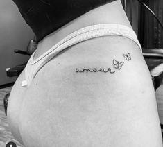 a woman's lower back tattoo with the word mama written in cursive writing