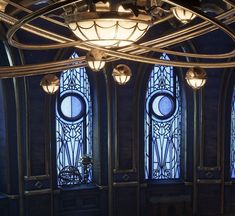 an ornate room with stained glass windows and chandelier hanging from it's ceiling