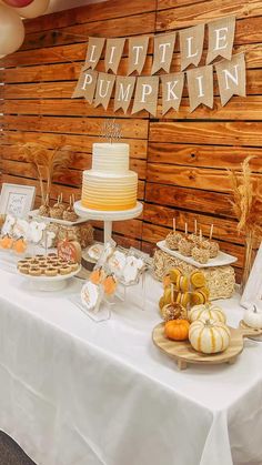 a table topped with lots of desserts next to a sign that says little pumpkin