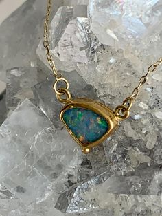 "Australian Opal 22k Gold Pendant Necklace This beautiful Opal is known as a Coober Pedy from the town of the same name, referred to as the \"opal capital of the world.\"  Wrapped in a 22k Gold bezel, a perfect backdrop to display all the vibrant color play of blue, purple, green, red and more. It is photographed in natural daylight and gorgeous at any angle. A solid 22k Gold granulation bead at bottom adds an additional point of interest. It is backed in 10k Gold and dangles from a 14k Gold chain with 18k Gold \"S\" clasp and links." Fine Jewelry In Gold With Ethiopian Opal, Ethiopian Opal Necklace For Formal Events, Formal Ethiopian Opal Necklace In Fine Jewelry Style, Unique Gold Opal Jewelry, Unique Opal Necklaces For Formal Occasions, Yellow Gold Opal Necklace For Anniversary, Formal Ethiopian Opal Gold Jewelry, Formal Gold Ethiopian Opal Jewelry, Formal Ethiopian Opal Necklace Fine Jewelry