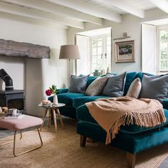 a living room filled with furniture and a fire place next to a couch in front of a fireplace