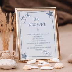 a sign that says the ring game next to seashells