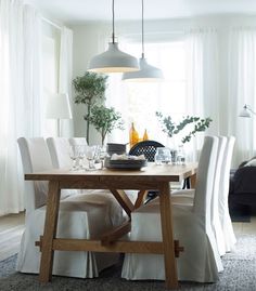 a dining room table with white chairs around it