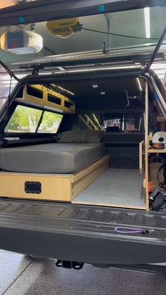 the back end of a truck with an open bed and storage compartment on it's side