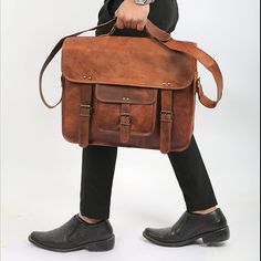 A Timeless Style that Never Goes Out of Fashion THE VINTAGE IS THE ULTIMATE IN CLASSIC LEATHER MESSENGER BAGS Made from the finest quality leather available, this full grain leather laptop briefcase is passionately handcrafted by the most skilled artisans. Looking for a stylish bag with a ton of storage space? You can easily fit a 15.6 inch laptop, and there's loads more room for your tablets, files, documents, cables, chargers, books, pens and just about anything else the student or professiona Vintage Brown Satchel Briefcase For Travel, Vintage Leather-lined Satchel Laptop Bag, Vintage Briefcase With Shoulder Strap, Vintage Leather Satchel, Vintage Brown Leather-lined Briefcase, Vintage Leather-handled Briefcase Shoulder Bag, Leather Messenger Bag Laptop, Real Leather Bags, Laptop Messenger Bags